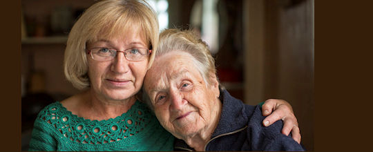 Portrait of an old woman with her adult daughter.